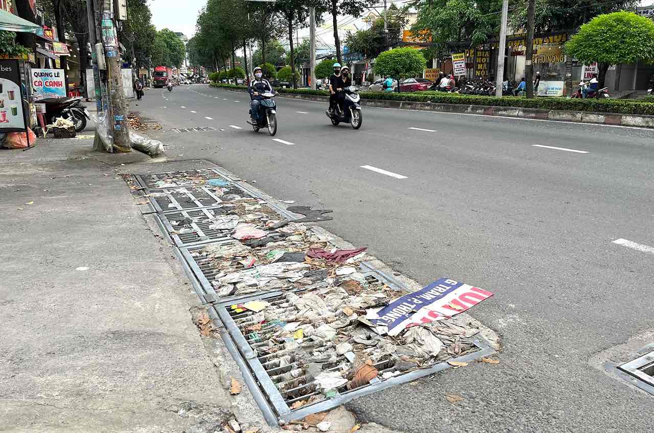 Rác bít kín các miệng cống thoát nước trên đường Đồng Khởi. Ảnh tư liệu: HAC